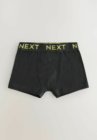 Svarta boxerkalsonger med en gul "NEXT"-logotyp på midjebandet. Tillverkade av slätt tyg med en åtsittande design och standard midjehöjd.