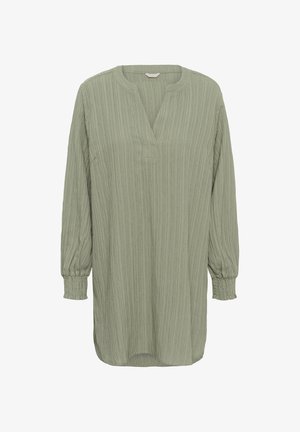 Zelený top s dlhými rukávmi a textúrovaným rebrovaným dizajnom. Má výstrih do tvaru V a nariasené manžety. Pohodlný strih s mierne predĺženým zadným dielom.