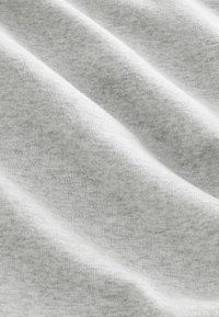 Light gray fabric with a soft texture, featuring slight folds and wrinkles, indicating a knit or cotton blend material.