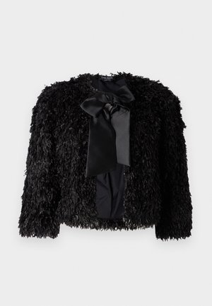 Czarna, futrzana kurtka z okrągłym dekoltem, długimi rękawami i dużą, satynową kokardą z przodu. Posiada teksturowaną, kudłatą powierzchnię.