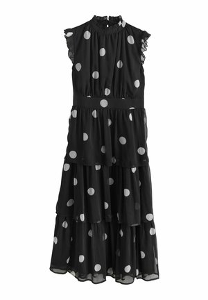 Black dress with white polka dots, tiered design, fabric features ruffled sleeves, high neckline, and a fitted waist.