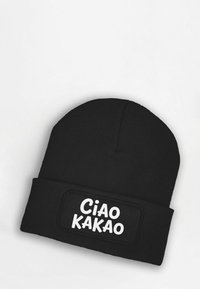 Black knit beanie with a turned-up cuff featuring a rectangular patch that reads "Ciao Kakao" in bold white letters. Soft texture.