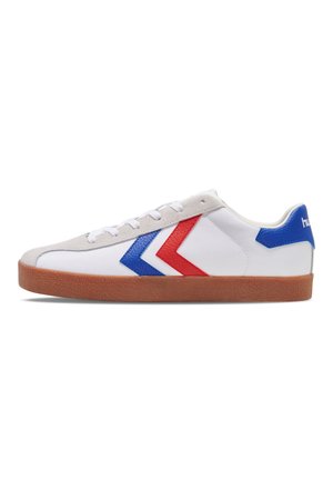 White sneaker with red and blue chevron accents, grey suede toe cap, white laces, and a tan rubber sole. Features a textured design.