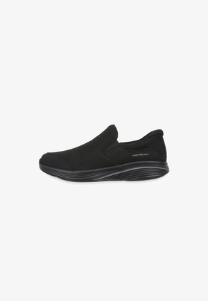 Black slip-on sneaker with textured knit upper, cushioned sole, and "Swiss Precision" label on side, designed for comfort and casual wear.