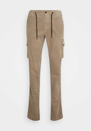 Pantalons cargo beiges en tissu texturé. Comprennent deux poches latérales, une taille à cordon de serrage et un léger évasement au niveau de l'ourlet.
