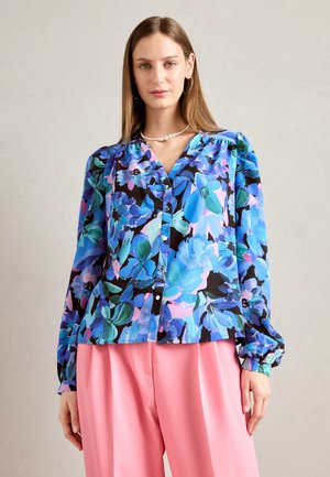 Blusa floreale multicolore con motivi blu, rosa e verdi su sfondo nero, chiusura a bottoni, e maniche lunghe con polsini elastici.