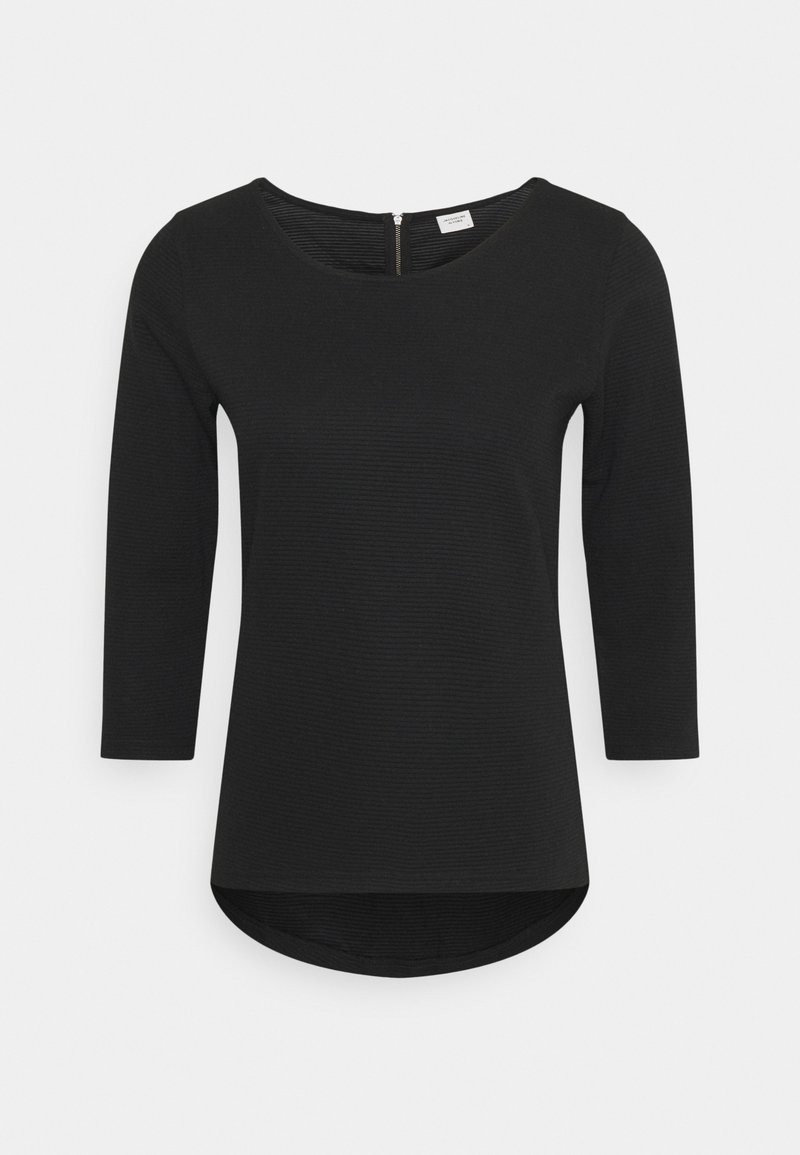 Haut noir à manches longues avec un décolleté en U, texture côtelée structurée et ourlet arrondi. Présente un discret détail de fermeture éclair au dos.