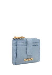 Blue leather cardholder with gold hardware, featuring a zip closure, multiple card slots, and embossed brand logo on the front.