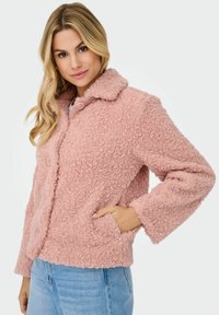 Pink faux fur jacket with a collared neckline, button closure, side pockets, and textured pattern. Features wide sleeves and a cropped fit.