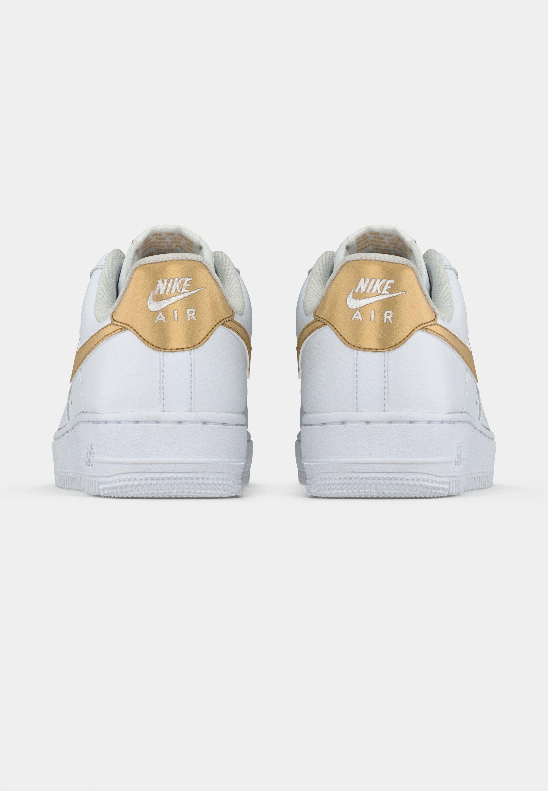 white and gold nike thea