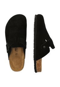 Svart mockasinslippers med korksula, justerbar rem och texturerad gummisula. Har rund tå och minimalistisk design.