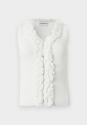 Haut blanc sans manches en maille côtelée avec un décolleté en V profond et un volant se prolongeant sur le devant, étiquette "Claudie Pierlot Paris" à l'intérieur du col.