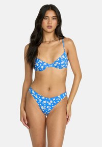 Blue floral bikini set featuring a triangle top and high-cut bottoms, with a light floral pattern, adjustable straps, and smooth fabric texture.