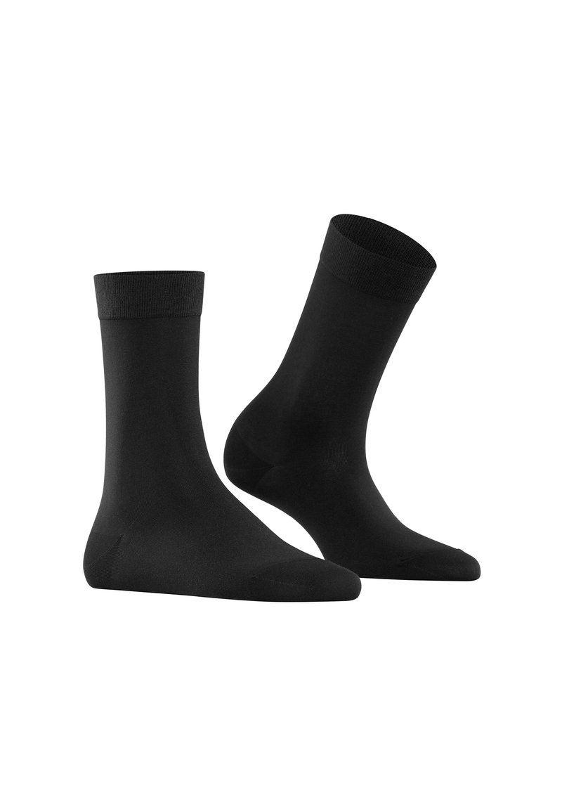 Calcetines de equipo negros hechos de un material suave y elástico. Cuentan con una puntera reforzada y un ribete acanalado para un ajuste seguro. Adecuados para uso casual.