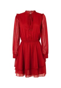 Abito rosso realizzato in tessuto trasparente con un motivo a pois. Presenta maniche lunghe, un colletto arricciato, una vita elastica e una gonna a strati.