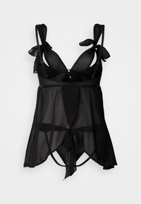 Camisole noire transparente avec bretelles réglables à nouer, tissu doux, ourlet évasé et éléments décoratifs pour un effet superposé.