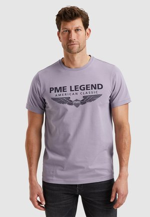 Fialové tričko vyrobené z bavlny, s potiskem černého loga s křídly a textem "PME LEGEND AMERICAN CLASSIC" na přední straně.