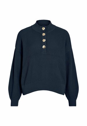 Tumši zils džempera trikotāža ar augstu apkakli, priekšpusē pieci zelta toņa pogas un viegli balona formā veidotas piedurknes. Teksturēts ribots audums.