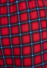 Rood geruit stof met een roosterpatroon met grotere effen rode vierkanten, versterkt door zwarte lijnen en lichtblauwe vierkanten. Glad textuur.