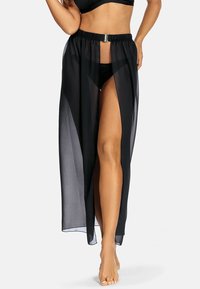 Czarna, przezroczysta spódnica z otwartym przodem, z wysokim rozcięciem i metalicznym akcentem w pasie. Miękka, lekka tkanina.