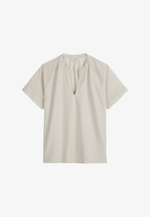 Chemise courte beige clair à manches courtes avec un col rond et une subtle fente à l'avant. Matériau en coton doux avec une coupe décontractée et des manches raglan.