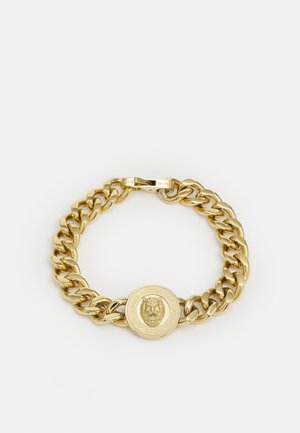 Bracelet en or avec un design de grandes maillons et un médaillon circulaire central présentant un motif de lion. Texture lisse, finition brillante.