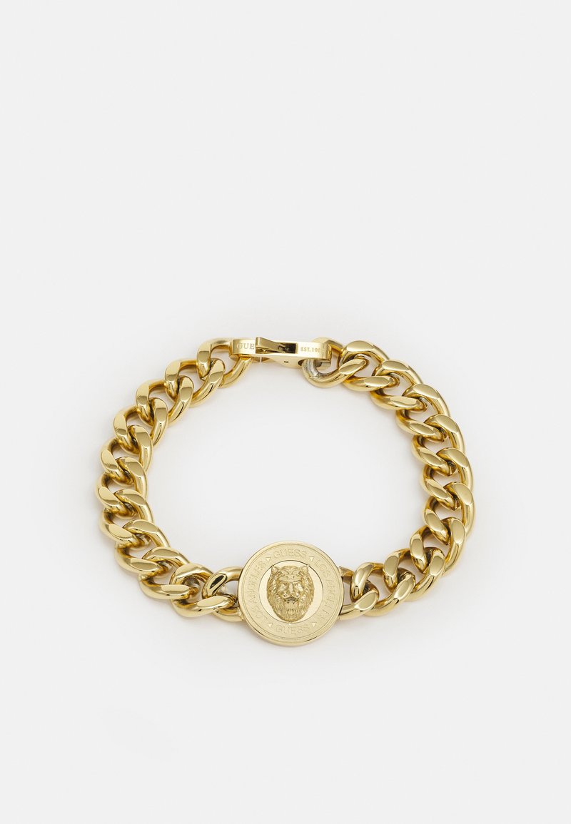 Gold chain bracelet with large linked design and a central circular medallion featuring a lion motif. Smooth texture, shiny finish.