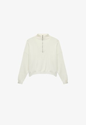 Suéter de manga larga en color blanco roto con cuello alto con cremallera y detalle de costura en forma de V en la parte delantera, presentado sobre un fondo blanco.