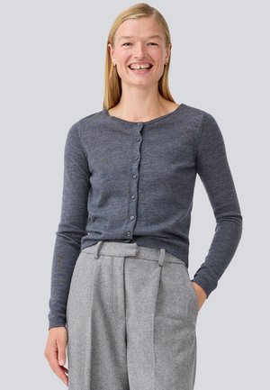 Dark grey cardigan made of soft fabric, featuring a round neck, long sleeves, and six front buttons. Herringbone patterned gray trousers.