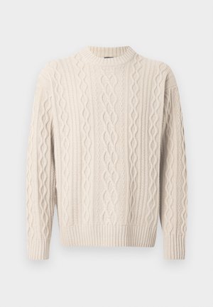 Krēmkrāsas adīts džemperis ar augstu kakla izgriezumu, raksturīgas reljefas rakstu un ribotām aprocēm un apakšmalu. Izgatavots no mīksta, elastīga auduma.