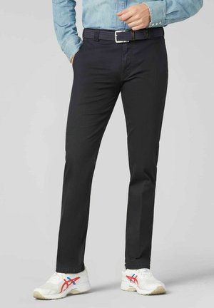 Black trousers with a slim fit, made of smooth fabric, paired with a woven belt and white athletic shoes with red and blue accents.