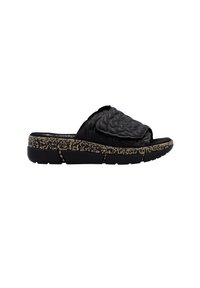 Black slide sandal with a textured floral design on the strap, featuring a speckled cork-like outsole and a comfortable flat sole.