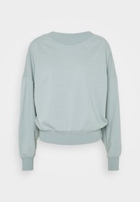 Jasnozielona skrócona bluza z okrągłym dekoltem, opuszczonymi ramionami i ściągaczami na rękawach. Gładka faktura, bez widocznych wzorów czy akcentów.