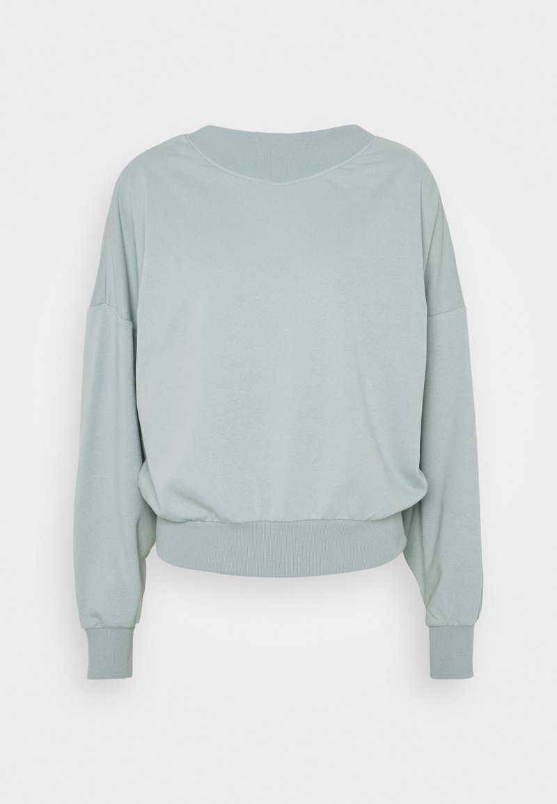 Jasnozielona skrócona bluza z okrągłym dekoltem, opuszczonymi ramionami i ściągaczami na rękawach. Gładka faktura, bez widocznych wzorów czy akcentów.