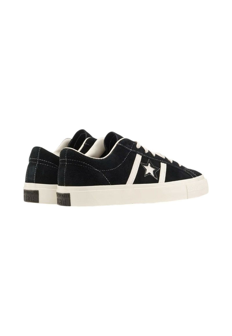 Pair of black low-top sneakers with white sole, white laces, and a white star logo on the side, viewed from the back left angle.