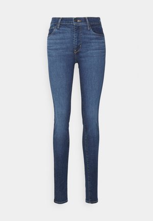 Tanke jeans iz modrega denima, s srednje visokim pasom, zankami za pas, sprednjimi žepi in klasičnim oblikovanjem s petimi žepi.