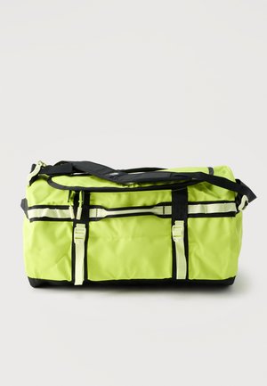 Sac de sport jaune-vert vif avec base noire, double poignées de transport, bandoulière réglable et compartiments zippés.