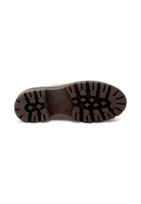 Semelle d'une botte beige avec des crampons profonds et robustes, conçue pour l'adhérence et la durabilité, présentée sur un fond blanc.