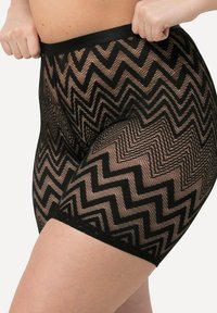 Zwarte mesh shorts met een chevronpatroon, voorzien van een effen zwarte tailleband en een gestructureerde stof. Close-up uitzicht met focus op ontwerp en detail.