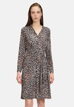Abito avvolgente con stampa leopardata in tessuto leggero; maniche lunghe, scollo a V e dettaglio in vita arricciato. Colori predominanti: sabbia, nero e marrone.