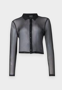 Musta läpikuultava pitkähihainen lyhythihaisen nappipusero, jossa on kaulus ja näkyvä tuotemerkki kauluksessa.