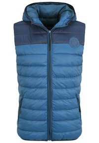 Blå pufferväst med en marinblå övre del, framzipper och två sidfickor. Den har en vadderad yta och en huva. Broderad logotypdetalj.