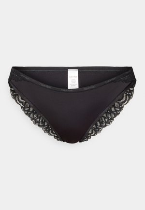 Zwarte slip met een gladde stoffen voorkant en kantaccenten aan de zijkanten. Bevat een Calvin Klein-logo op de tailleband.