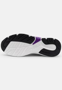 White and black athletic shoe sole with a patterned tread, featuring a purple accent and the Fila logo, designed for grip and support.