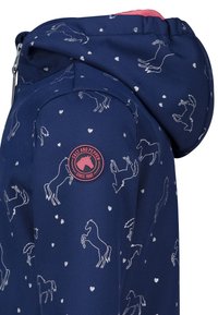Navy blue jacket featuring a hood, silver horse patterns, and small hearts. Includes a pink circular logo on the sleeve. Overall fabric is smooth.
