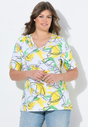 Hvid kortærmet V-hals T-shirt med et farverigt skildpadde-mønster i grønne, gule og sorte konturer. T-shirten er lavet af et letvægtsmateriale.