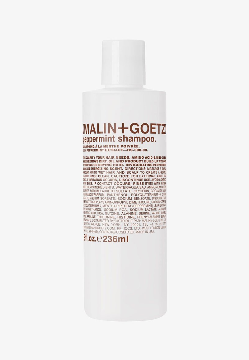 Bouteille de shampooing Malin+Goetz à la menthe poivrée, blanche avec texte marron, 236 ml, affichant les détails du produit, les ingrédients et les instructions d'utilisation.
