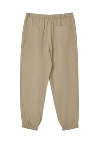 Pantaloni jogger beige con vita elastica, due tasche posteriori e polsini elastici alla caviglia. Realizzati in un tessuto morbido e leggero.