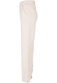 Lyserøde joggebukser med elastisk midje, sidelommer og rett ben-design med subtile sidesømmer.