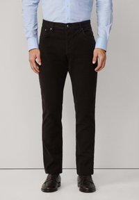Zwarte broek van katoen twill, met een slim fit, vijf-pocket ontwerp en metalen hardware accenten. Gemaakt met een lichtblauw overhemd.